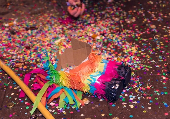 Pinata smashed with bright coloured confetti