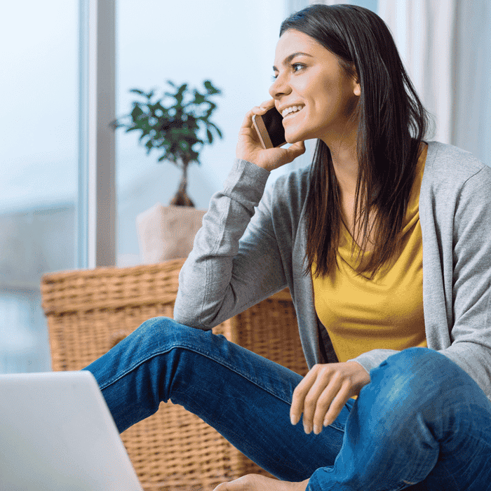 Woman working at computer and talking on phone